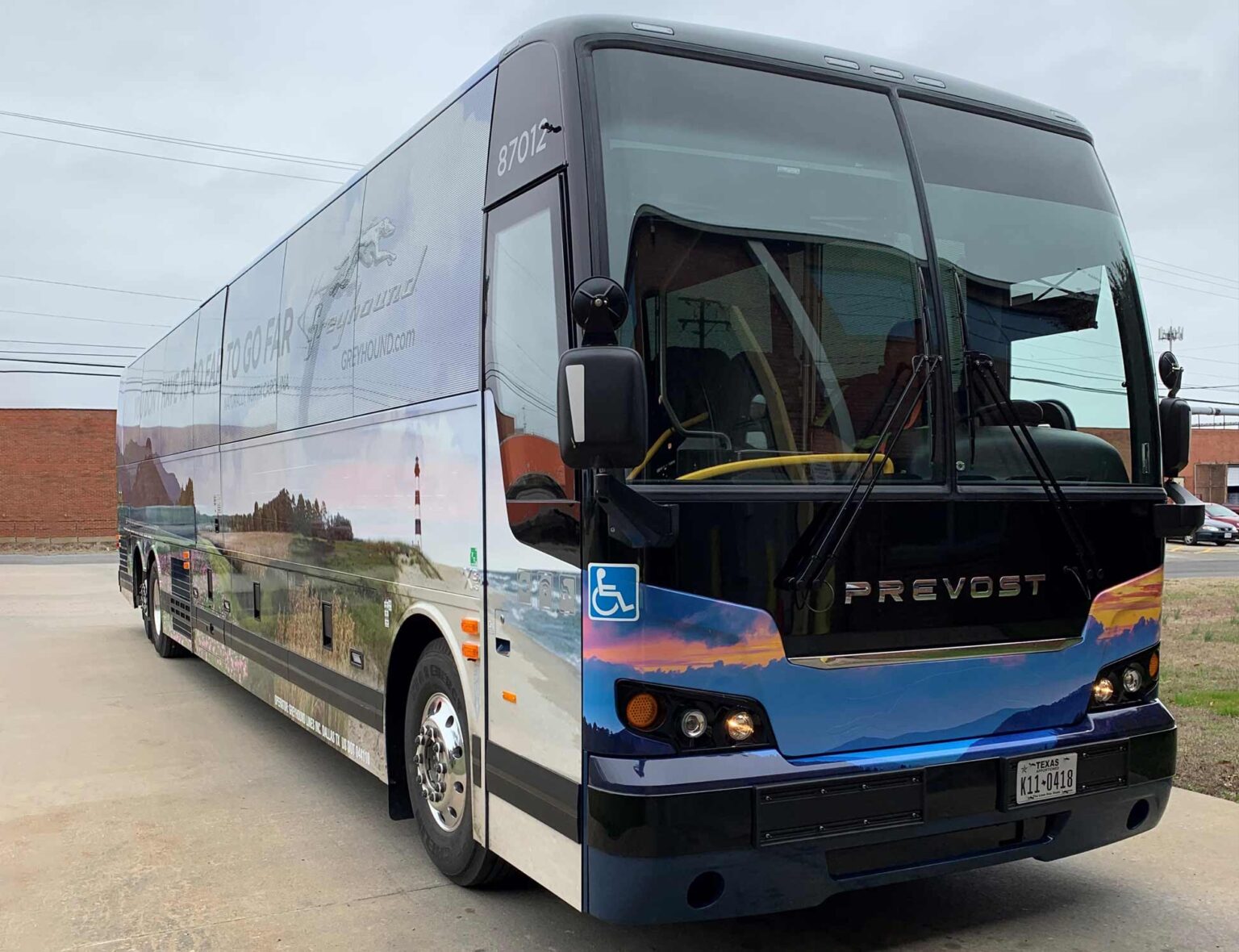 Greyhound bus graphics with branding on windows and all of body