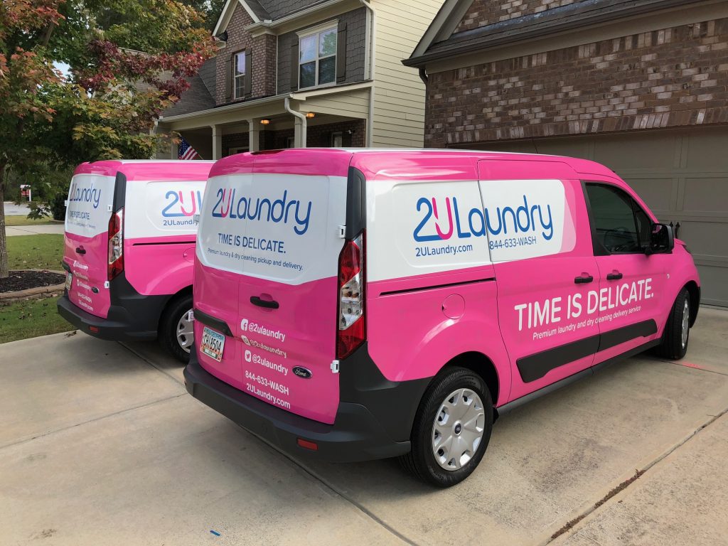 Two 2U Laundry vans with custom van graphics